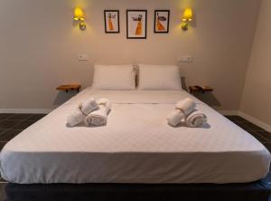 a bedroom with a large bed with towels on it at Holy Pansiyon in Kaş