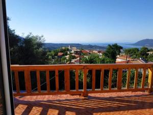 a wooden balcony with a view of a town at Lefkada Villas Panoramic in Katouna