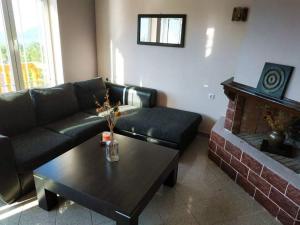 a living room with a couch and a coffee table at Lefkada Villas Panoramic in Katouna