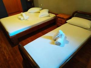 two beds in a room with shoes on them at Lefkada Villas Panoramic in Katouna