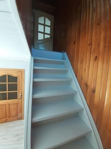 a stair case in a room with a door at VĖJO16 in Biržai