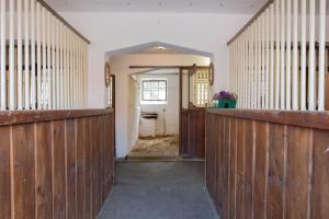 an empty room with wooden walls and a hallway at Penzion Štekrův Mlýn in Františkovy Lázně