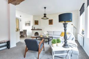 a living room with a couch and a table at Royaal appartement in het centrum van Yerseke in Yerseke