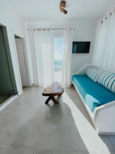 a room with a couch and a table in front of a window at Eternal Suites in Mikonos