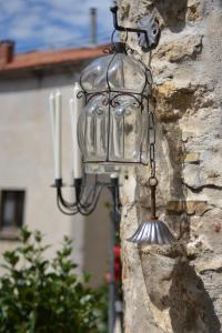 a bird feeder hanging on a stone wall at Borgo Manca Suite in Sasso di Castalda