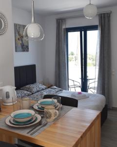 a dining room with a table with plates on it at 4Bro Rooms Laerma Village in Láerma