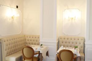 a dining room with two tables and two chairs at Hotel Villa Pinciana in Rome