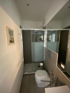 a bathroom with a toilet and a glass shower at Casa nel Cuore di Zoagli in Zoagli