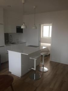 a kitchen with a white island in a room at Triana Parque VV in Las Palmas de Gran Canaria