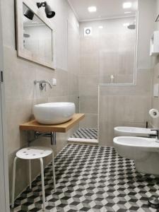 a bathroom with a sink and two toilets in it at B&B TrentaQuattro in Campomarino