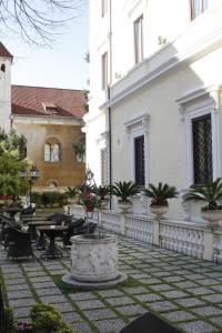 a courtyard with tables and chairs and a building at Hotel Villa Pinciana in Rome