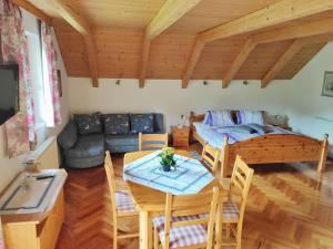 a living room with a table and a couch at Gästehaus Laßnig in Ebene Reichenau