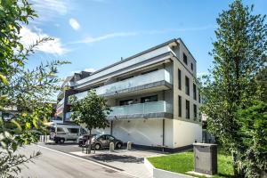 a building with a car parked in a parking lot at Apartment Silberdistel - GriwaRent AG in Interlaken