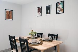 a dining room with a wooden table and chairs at Basin Cottage Peak District in Whaley Bridge