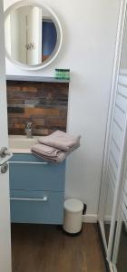 a bathroom with a blue sink and a mirror at Concept Appart'Hôtel Lannion - Côte de Granit Rose in Lannion