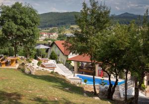 a house with a swimming pool in a yard at Apartment Mario in Otočac