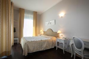 Een bed of bedden in een kamer bij Hotel Marconi