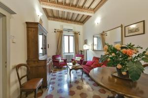 a living room with a couch and a table at Residenze d'Epoca Palazzo Coli Bizzarrini in Siena