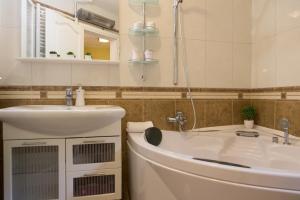 a bathroom with a sink and a toilet and a mirror at Apartment Mario in Otočac +36 photos