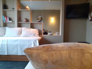 a bedroom with a bed and a person in a mirror at Center Vistas in San Carlos de Bariloche