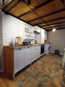 a large kitchen with white cabinets and a sink at Studio Krakow old town apartment in Krakow