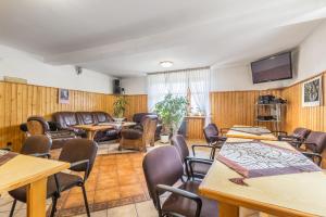 a conference room with tables and chairs and a tv at Dom Wczasowy Jesionkówka in Poronin