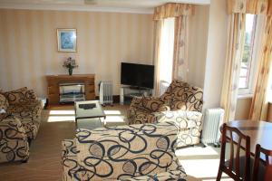 ein Wohnzimmer mit zwei Sofas und einem Fernseher in der Unterkunft The Devoncourt Resort in Exmouth