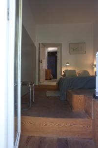 a bedroom with a bed and a table in it at ribeira dos marinheiros azul in Sintra