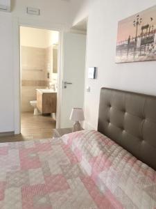 a bedroom with a bed and a bathroom with a sink at B&B San Giovanni in Lamezia Terme