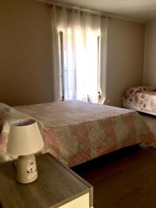 a bedroom with a bed and a table with a lamp at B&B San Giovanni in Lamezia Terme