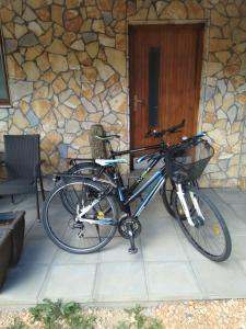 a bicycle parked in front of a stone building at Apartmani Sara i Marta in Otočac