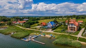 an aerial view of a house on an island in the water at Niebieska Tawerna in Węgorzewo