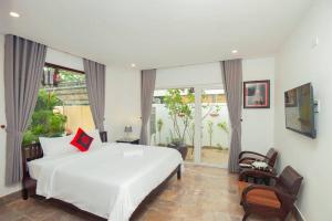 ホイアンにあるGreen Grapefruit Villaのベッドルーム(白いベッド1台、大きな窓付)