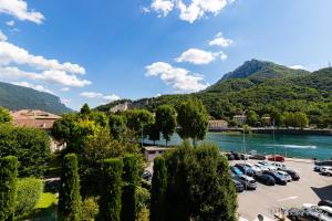 a parking lot with cars parked next to a lake at B&B Casa Fortuna in Lecco