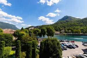 un estacionamiento con autos estacionados junto a un lago en B&B Casa Fortuna, en Lecco