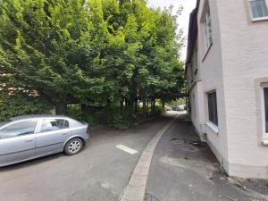 a car parked in a parking lot next to a building at Schwarzer Adler in Streitberg