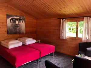 a room with a bed with a picture of a cow at Dalen Gaard camping og hytter in Geiranger