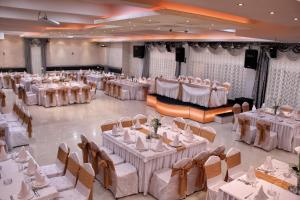 a large banquet hall with white tables and chairs at ESTRADA Lux in Belgrade