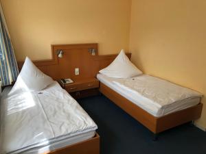 Postel nebo postele na pokoji v ubytování Hotel Haus am Rieth