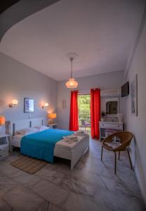 a large bedroom with a bed and a table at Stella Studios in Poros