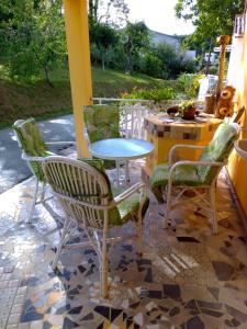 a patio with chairs and a table on a patio at Apartman SIRENA in Pićan