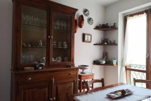 a dining room with a wooden cabinet with glasses on it at VelaLatina Residence B&B Soverato in Soverato Marina