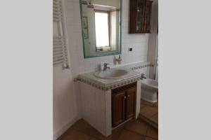 a bathroom with a sink and a mirror and a toilet at VelaLatina Residence B&B Soverato in Soverato Marina +34 photos