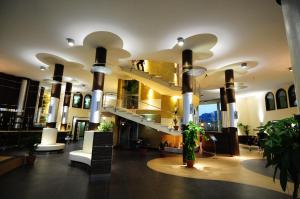 a lobby of a building with a spiral staircase at Corte dei Greci Resort & Spa in Cariati