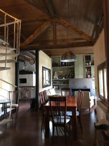 una sala da pranzo e un soggiorno con tavolo e sedie di La Masía de Navas a Navas del Pinar
