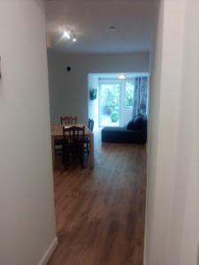 a dining room and living room with a table and chairs at Ferienwohnung Linde Otzenhausen in Nonnweiler