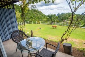a table and chairs and a horse in a field at Phang Nga Viewpoint in Phangnga