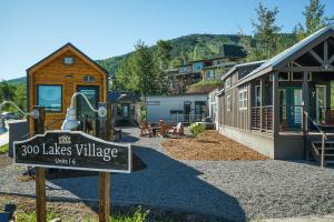 a sign that says the lakes village with a house at Tiny Homes at Powderhorn Mountain Resort in Mesa
