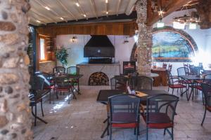 a restaurant with tables and chairs and a fireplace at Penzion Samorost in Jarošov nad Nežárkou