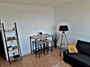 a living room with a table and chairs and a couch at Casterneau3 in Nantes